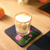 a glass of milk sitting on top of a coaster