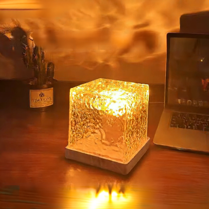 LED Night Light with water ripple effect illuminating a cozy space on a wooden desk.